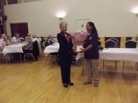 Lion Pal presenting bouquet to Mayoress